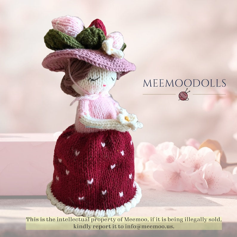 a pink teddy bear with a pink hat on