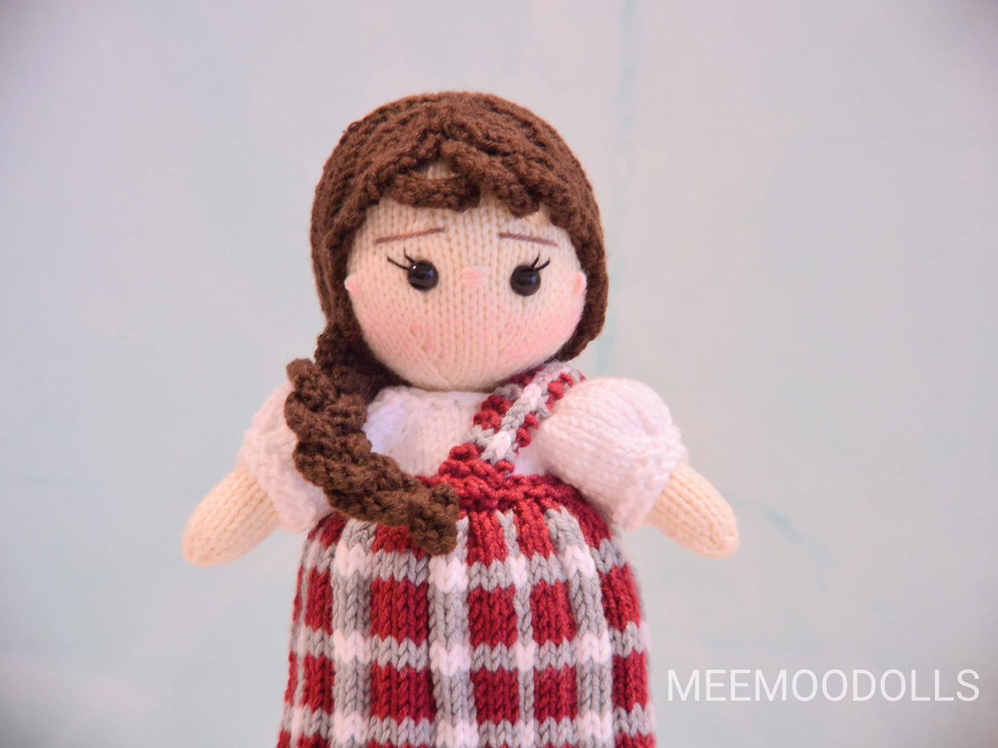 a little girl is holding a teddy bear