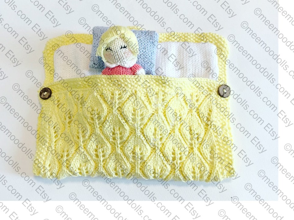 a yellow teddy bear sitting on a bed