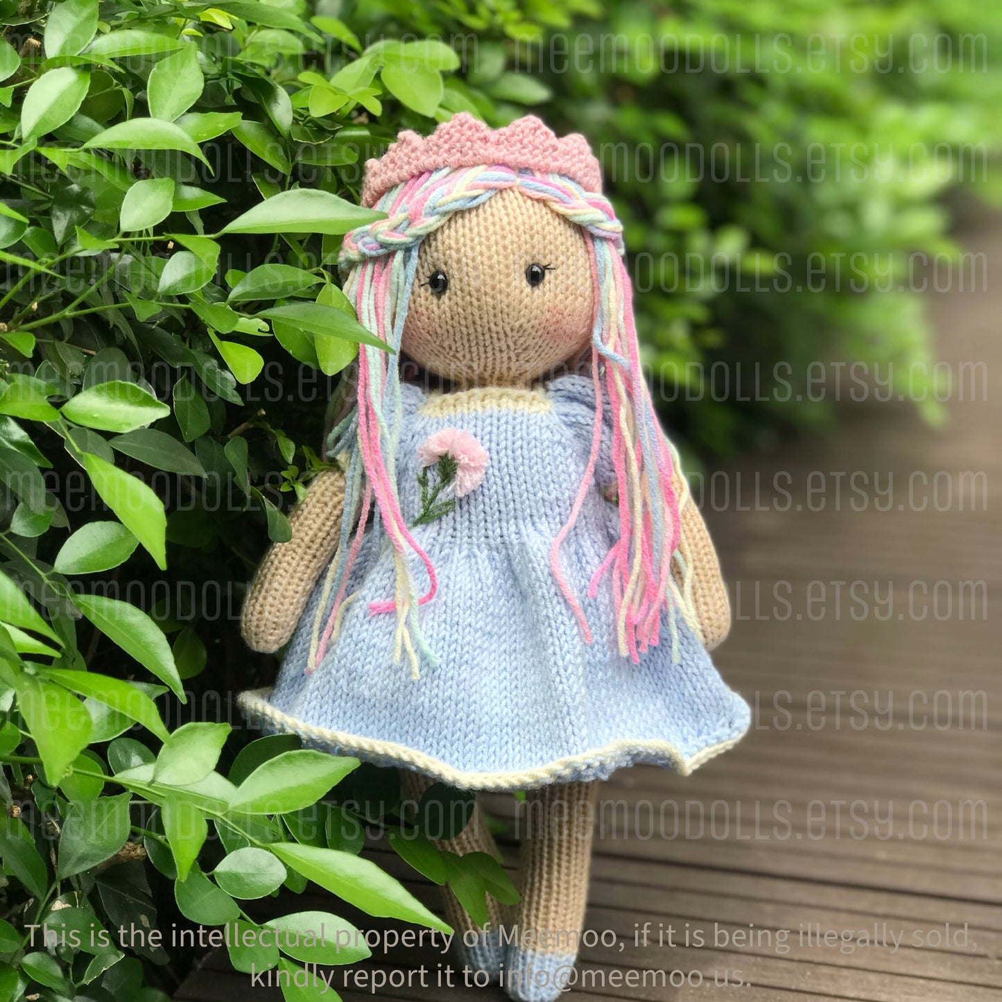 a pink teddy bear wearing a dress and a hat