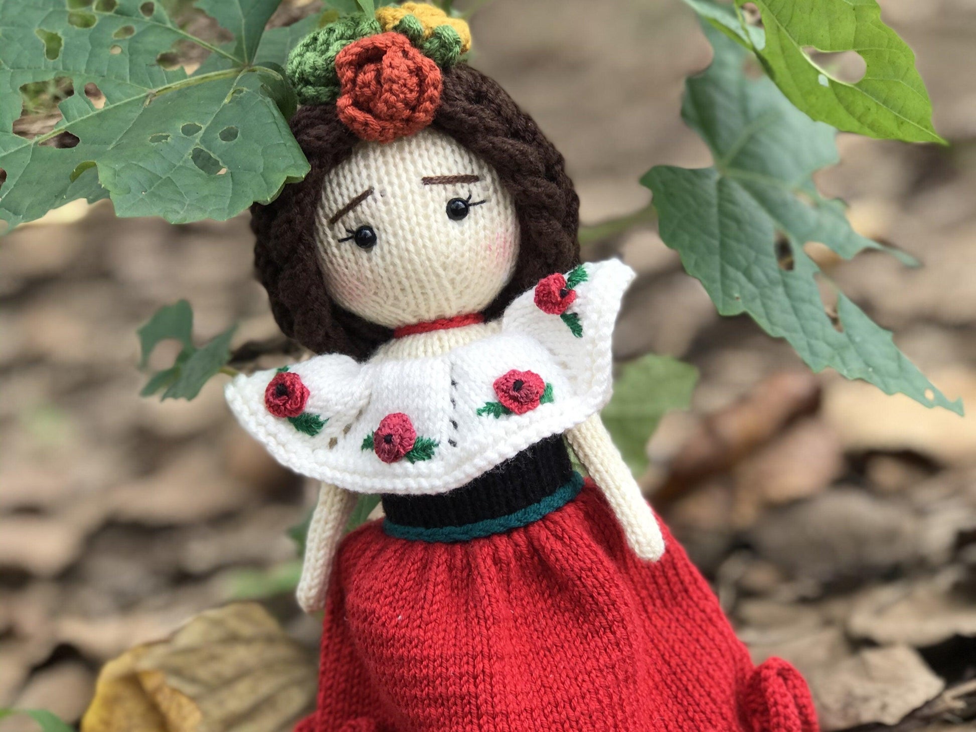 a teddy bear in a red dress holding a teddy bear 