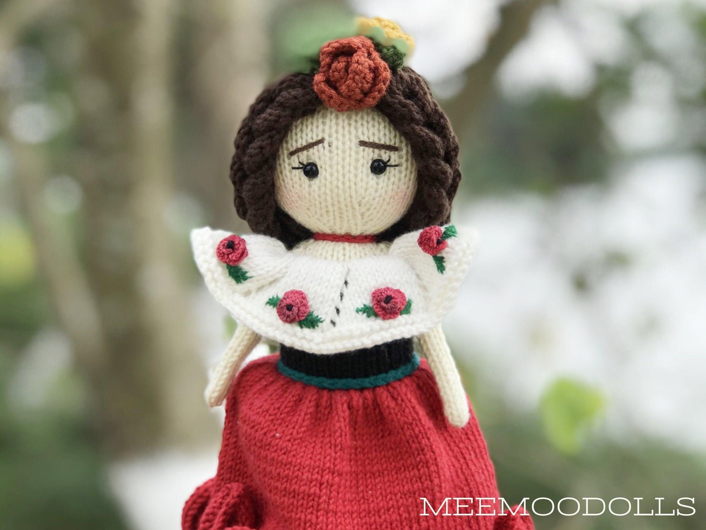 a red and white teddy bear in a red dress 