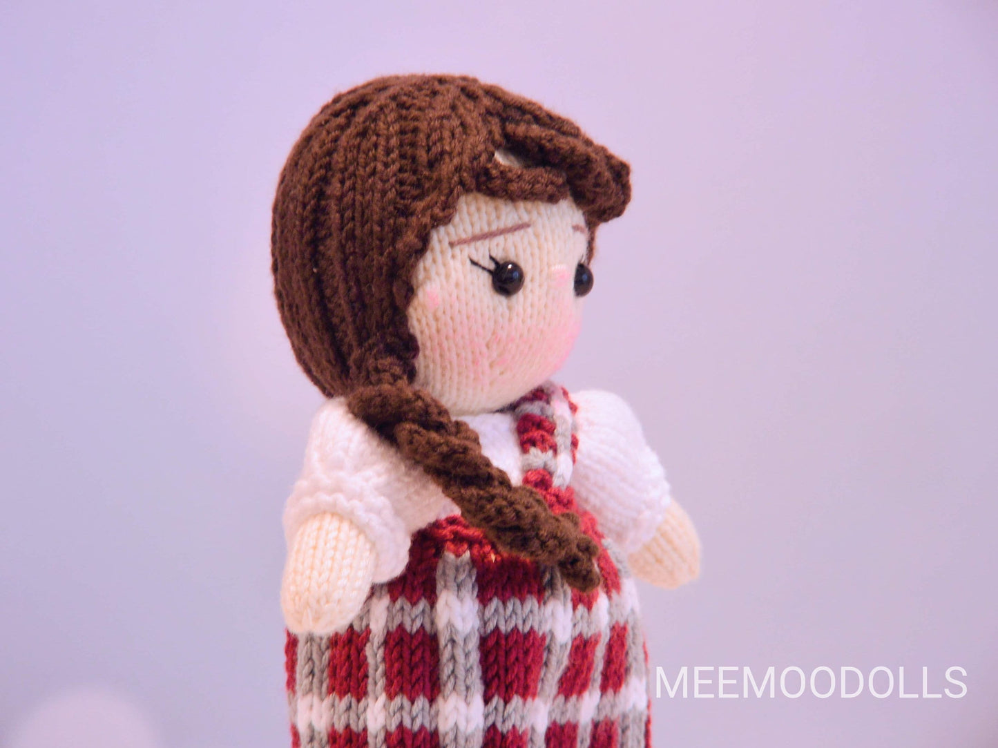 a teddy bear wearing a red and white dress 