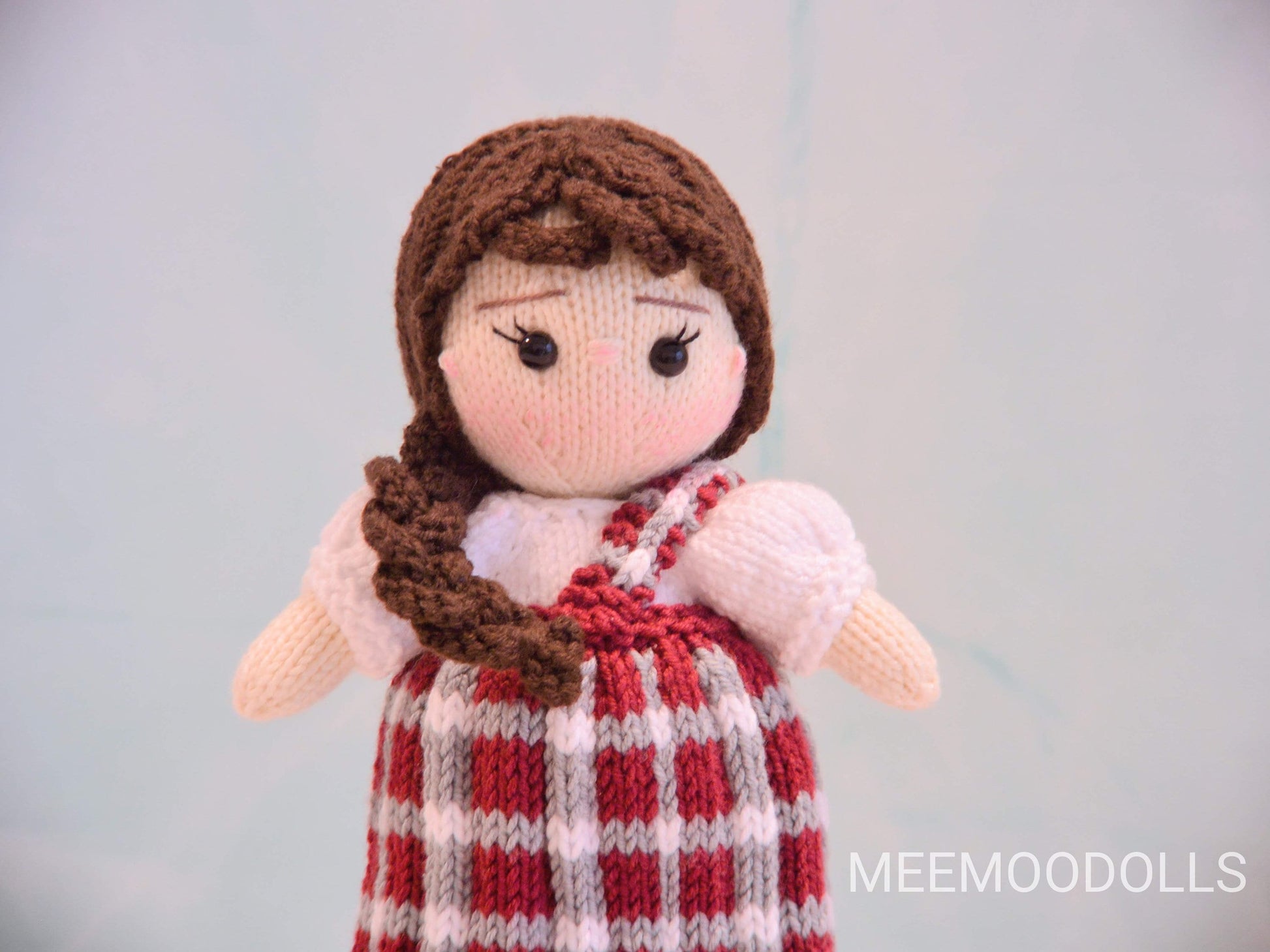 a little girl is holding a teddy bear 