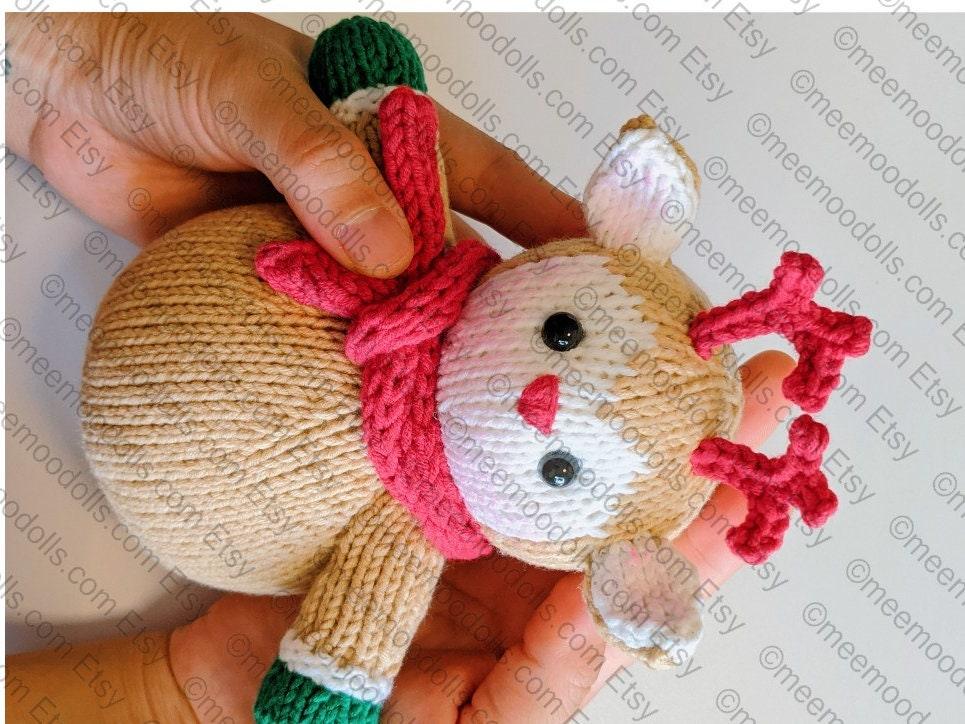 a person holding a teddy bear on a beach 